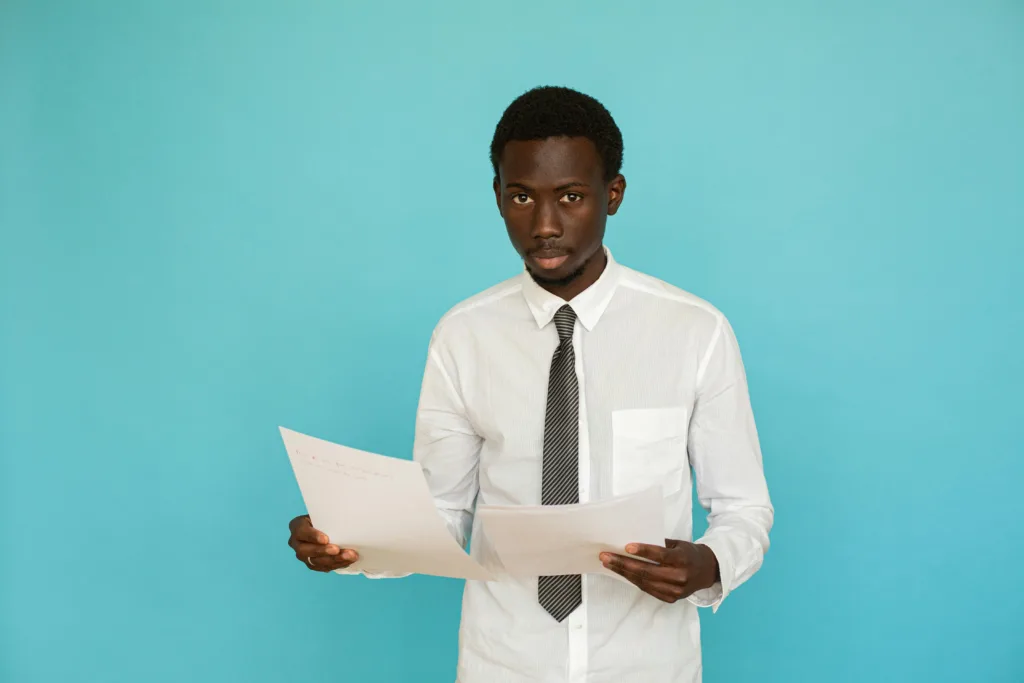 An image of a man staring while holding tax audits